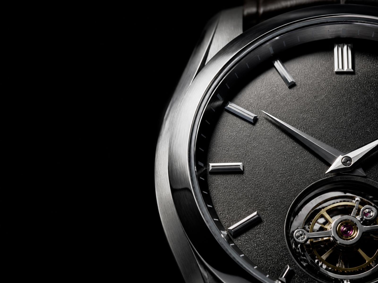 Macro detail of a mechanical watch dial and brushed steel case